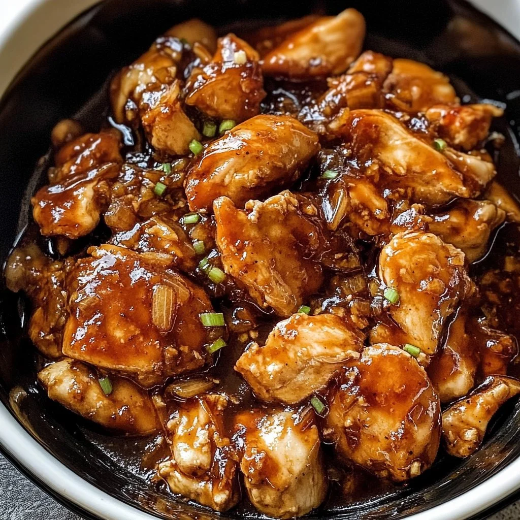 Crockpot Honey Garlic Chicken dish garnished with green onions and sesame seeds